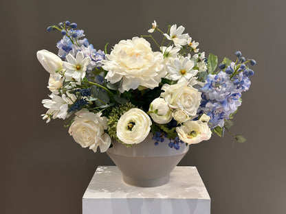 Blue Sunshine centerpiece rental with white garden roses, white peonies, blue hydrangea, blue delphinium, white ranunculus, white cosmos, and lush greenery in gray bowl vase on white pedestal | Reno, Lake Tahoe & Sacramento