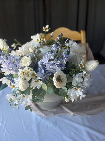 Blue Sunshine centerpiece rental with blue hydrangea, white garden roses, white anemones, white cosmos, and lush eucalyptus on blue linen wedding reception table at rustic indoor venue | Reno, Lake Tahoe & Sacramento

