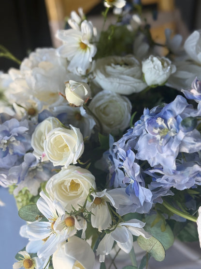 Macro close-up of Blue Sunshine centerpiece rental blooms with white garden roses, blue hydrangea, white ranunculus, and white cosmos in bright natural light | Reno, Lake Tahoe & Sacramento