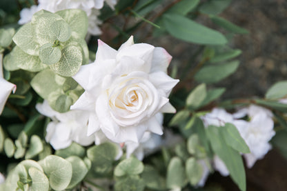 Macro close-up of white garden rose bloom with lush eucalyptus from Enchanted aisle flower rental at outdoor wedding venue | Reno, Lake Tahoe & Sacramento