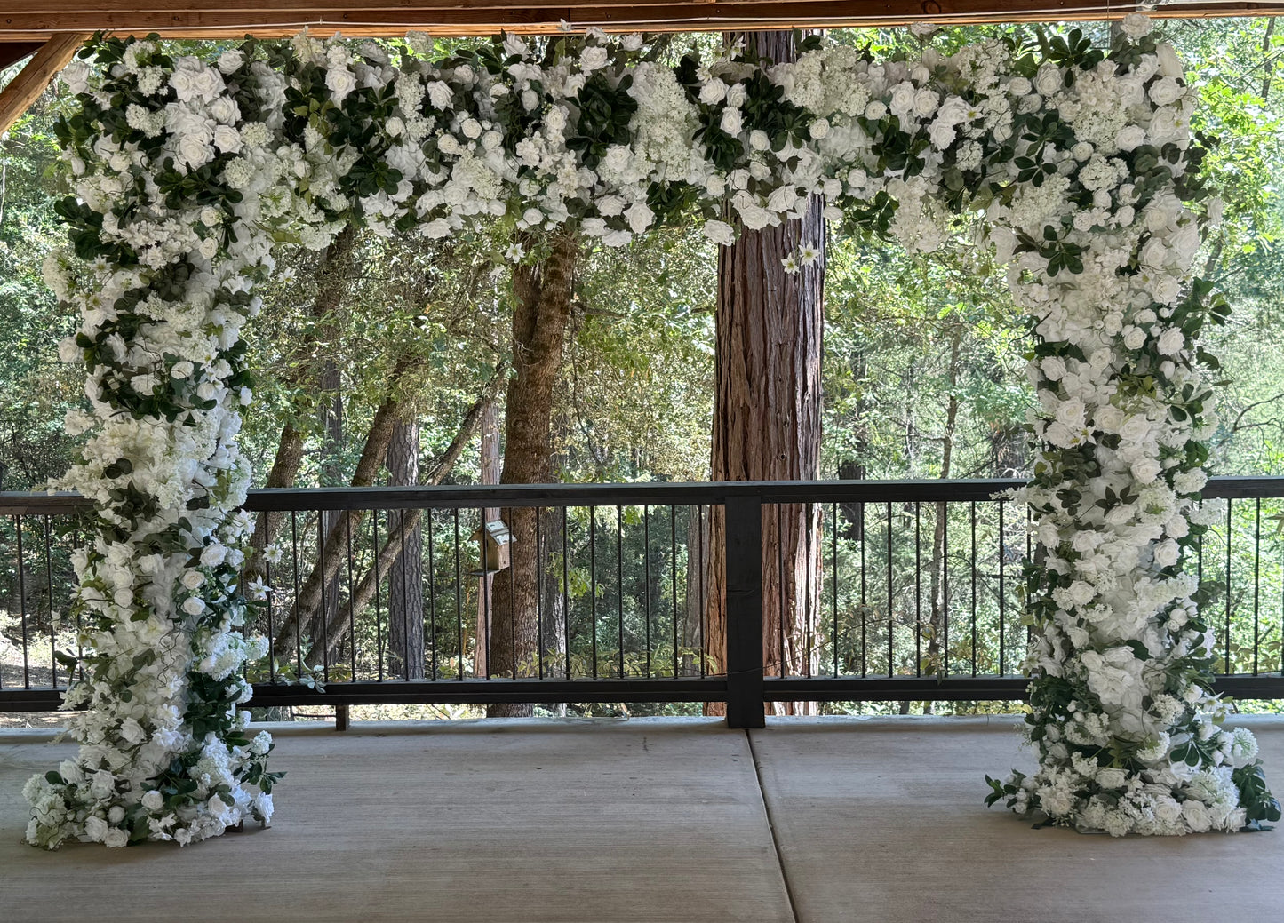 Full Daydream arch rental with white roses, hydrangea, greenery at outdoor redwood forest wedding venue | Reno, Lake Tahoe & Sacramento