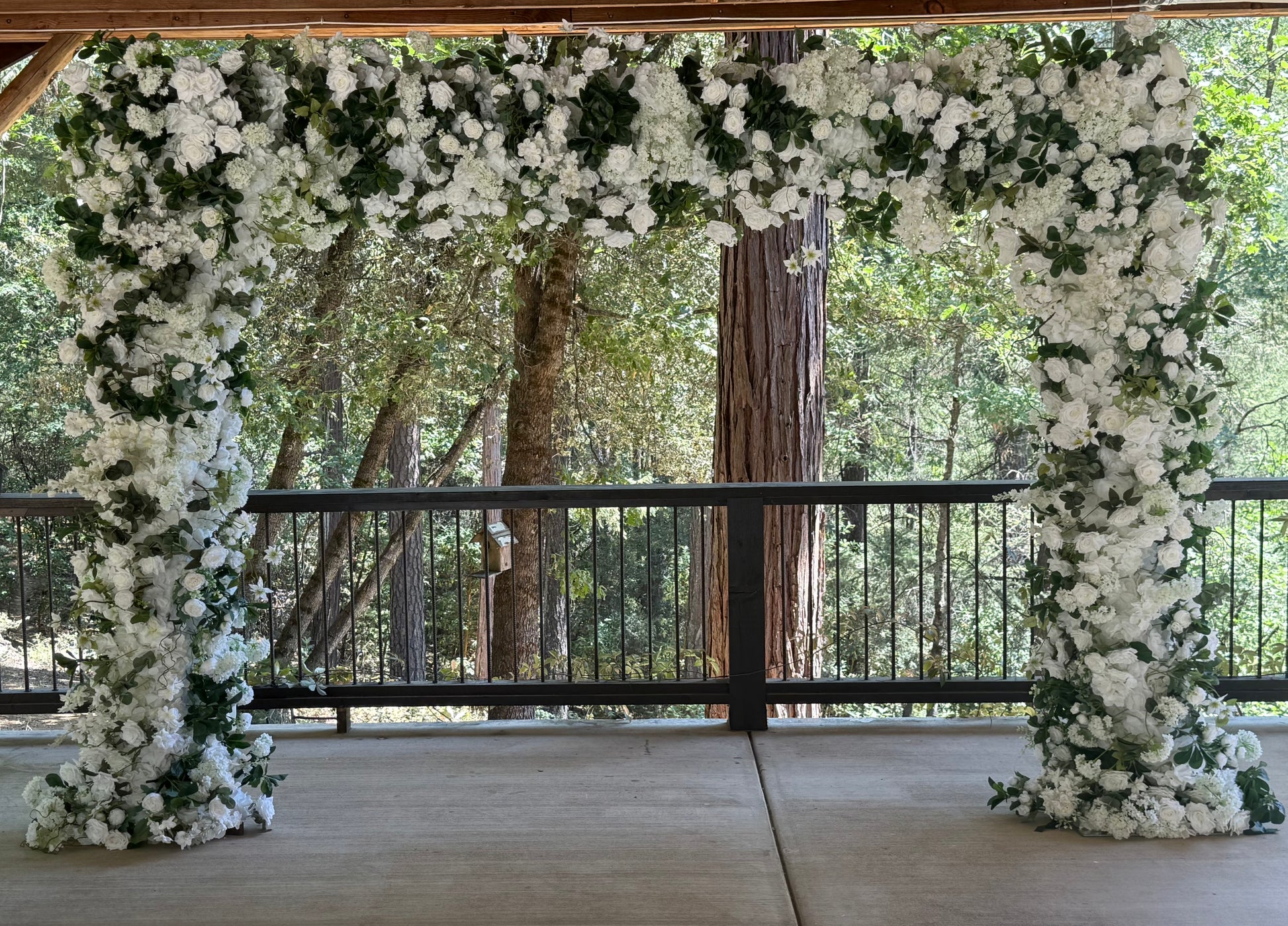 Full Daydream arch rental with white roses, hydrangea, greenery at outdoor redwood forest wedding venue | Reno, Lake Tahoe & Sacramento