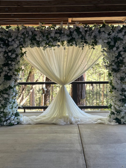 Full Daydream arch rental with white roses, hydrangea, greenery, and flowing white chiffon drapery at outdoor redwood forest wedding venue | Reno, Lake Tahoe & Sacramento