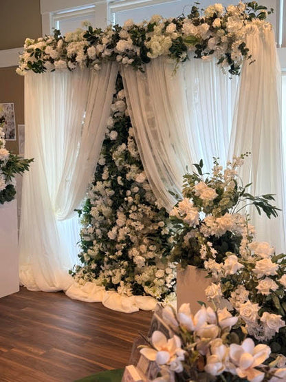 Daydream flower wall rental with white roses, white hydrangea, and lush greenery with flowing white fabric draping as wedding ceremony backdrop | Reno, Lake Tahoe & Sacramento