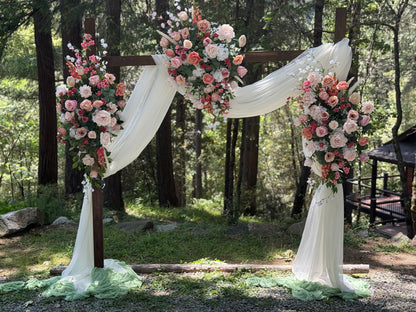 Full setup of Delicate arch adornment rental with blush and white florals cascading down rustic wood arch with white drapery | Reno, Lake Tahoe & Sacramento