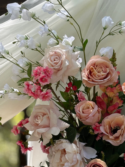 Close-up of Delicate arch adornment rental with blush garden roses, anemones, sweet peas, ranunculus, snapdragons and pink spray roses in bright natural sunlight | Reno, Lake Tahoe & Sacramento