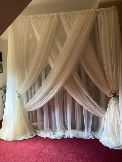 White chiffon drapery rental as full crossed backdrop with blush floral tie-backs at indoor wedding venue | Reno, Lake Tahoe & Sacramento