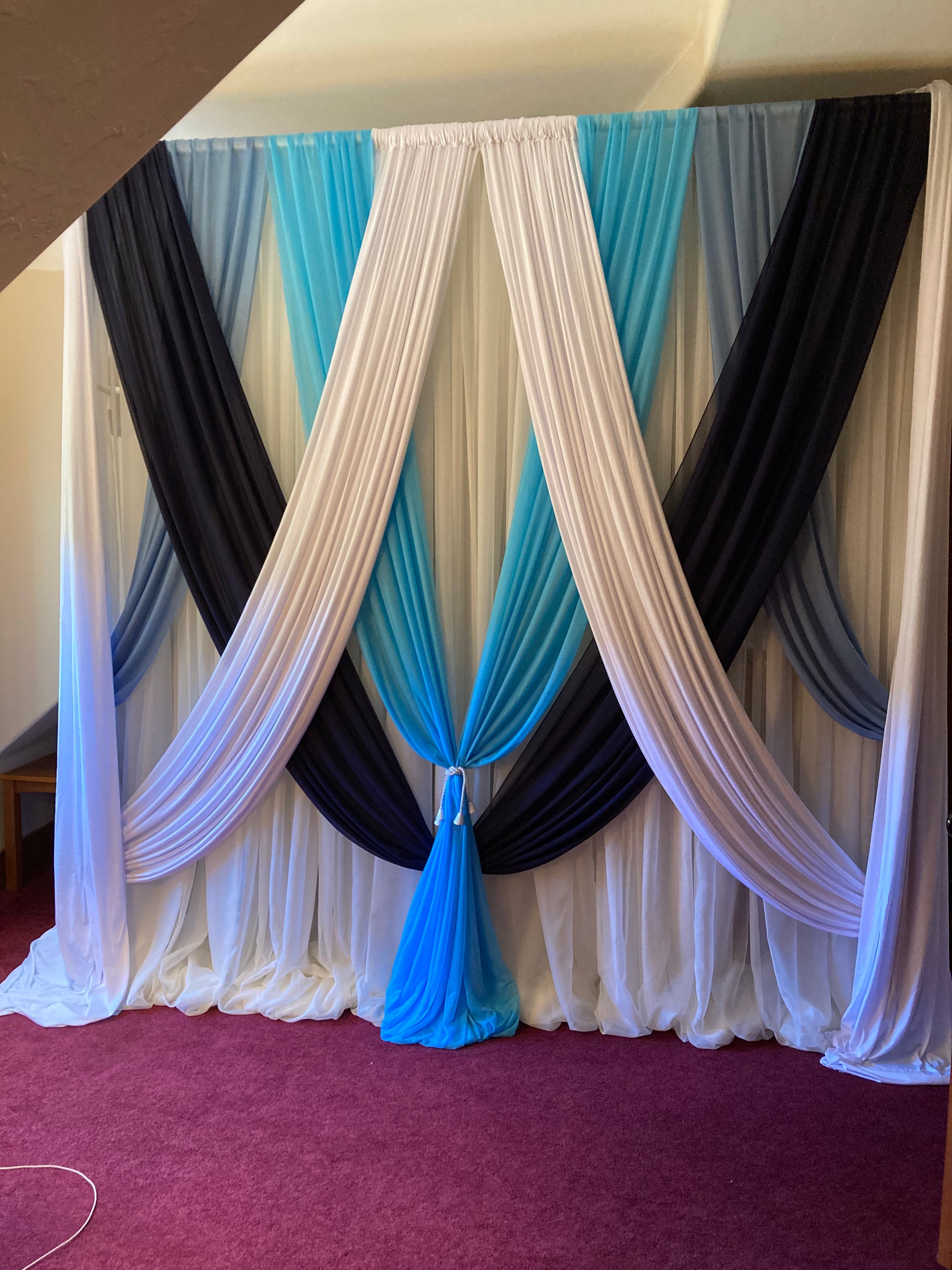 Custom multi-color chiffon drapery rental in white, teal, and navy styled as layered backdrop at indoor event venue | Reno, Lake Tahoe & Sacramento