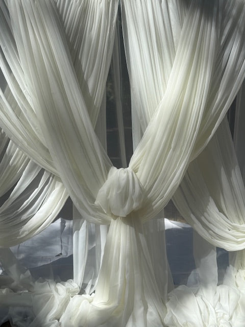 Close-up of white chiffon drapery rental with knotted fabric tie detail in natural sunlight | Reno, Lake Tahoe & Sacramento