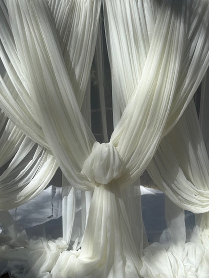 Close-up of white chiffon drapery rental with knotted fabric tie detail in natural sunlight | Reno, Lake Tahoe & Sacramento