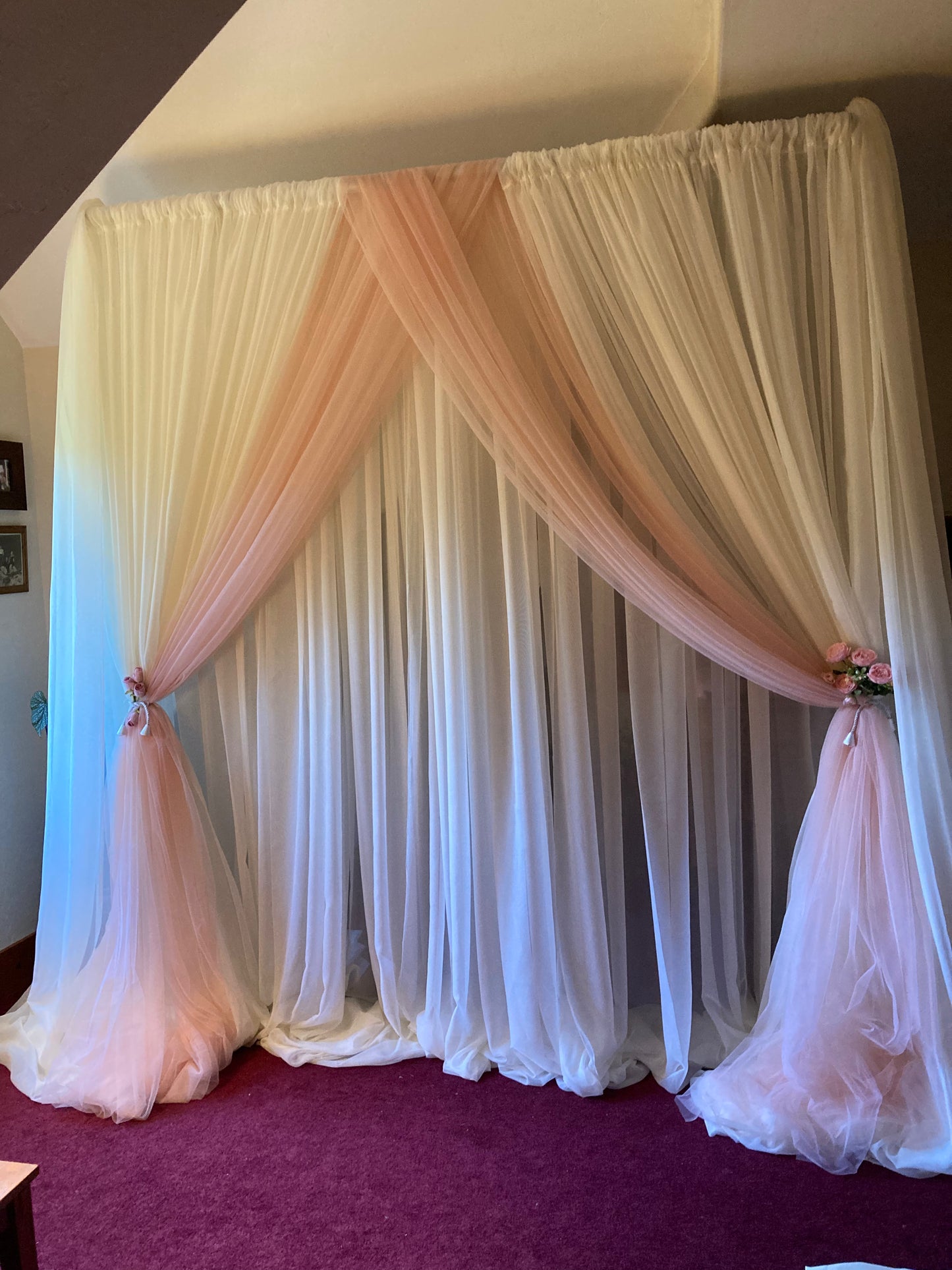 White and blush pink chiffon drapery rental styled as layered backdrop with floral tie-backs at indoor wedding venue | Reno, Lake Tahoe & Sacramento