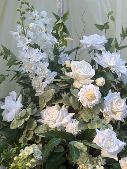 Close-up of Enchanted floral urn rental with white roses, white delphinium, white dahlias, white scabiosa, and lush greenery at indoor wedding venue | Reno, Lake Tahoe & Sacramento