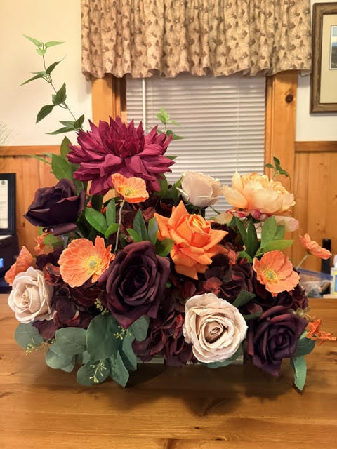 Evermore Centerpiece close-up of plum roses and coral poppy