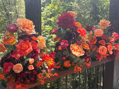 Close-up of 3 Evermore Fall aisle flower rentals on wooden railing with coral garden roses, orange dahlias, burgundy ranunculus, and eucalyptus at outdoor redwood forest wedding | Reno, Lake Tahoe & Sacramento