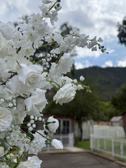 Close-up of Fairytale double moon arch rental blooms with white garden roses, white delphinium, and baby's breath with mountain backdrop | Reno, Lake Tahoe & Sacramento
