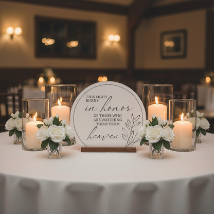 In Memory Sign Rental with Candle displayed on elegant wedding reception table with white linen surrounded by white rose bud centerpiece arrangements in crystal vases and white pillar candles in glass hurricane vases in warm romantic candlelit lighting | Reno, Lake Tahoe & Sacramento