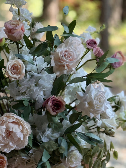 Close-up of Love Story urn rental blooms with blush garden roses, mauve roses, white hydrangea, and eucalyptus at outdoor pine forest wedding venue | Reno, Lake Tahoe & Sacramento