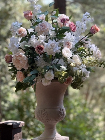 Love Story floral stone urn rental overflowing with blush, mauve, and cream garden roses, white delphinium, and lush greenery at outdoor wedding venue | Reno, Lake Tahoe & Sacramento