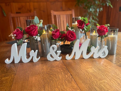 Mr & Mrs Wood Sign Rental on wooden table with red rose and baby's breath cylinder vase arrangements and flameless candles at rustic barn wedding reception | Reno, Lake Tahoe & Sacramento