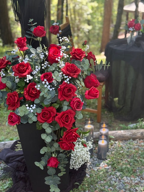 Close-up of red rose urn with bold red roses, baby's breath, at outdoor forest wedding | Reno, Lake Tahoe & Sacramento