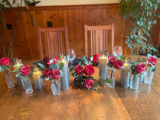 Red rose centerpiece rental set with bold red roses, baby's breath, and eucalyptus in glass bud vases styled on reception table with flameless candles | Reno, Lake Tahoe & Sacramento