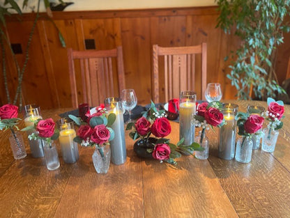 Red rose centerpiece rental set with bold red roses, baby's breath, and eucalyptus in glass bud vases styled on reception table with flameless candles | Reno, Lake Tahoe & Sacramento