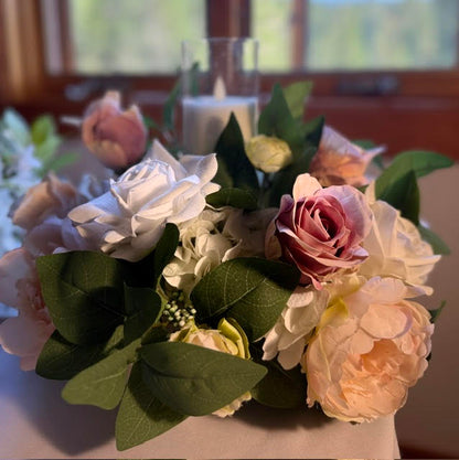Small Love Story Centerpiece with lit candle on white tablecloth