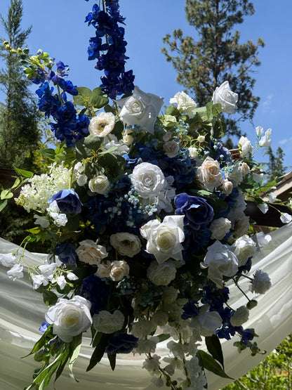 Close-up of Sweet Nothings arch adornment rental showing navy blue hydrangea, white garden roses, anemones, and blue delphinium in bright natural light | Reno, Lake Tahoe & Sacramento