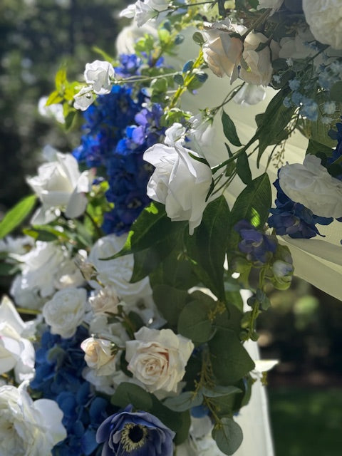 Close-up of Sweet Nothings arch adornment rental showing navy blue hydrangea, white garden roses, anemones, and blue delphinium in bright natural light | Reno, Lake Tahoe & Sacramento