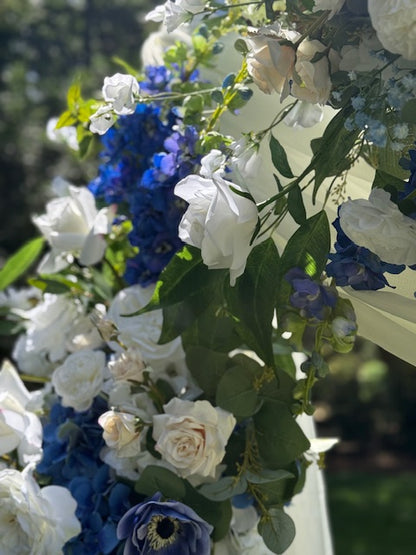 Close-up of Sweet Nothings arch adornment rental showing navy blue hydrangea, white garden roses, anemones, and blue delphinium in bright natural light | Reno, Lake Tahoe & Sacramento