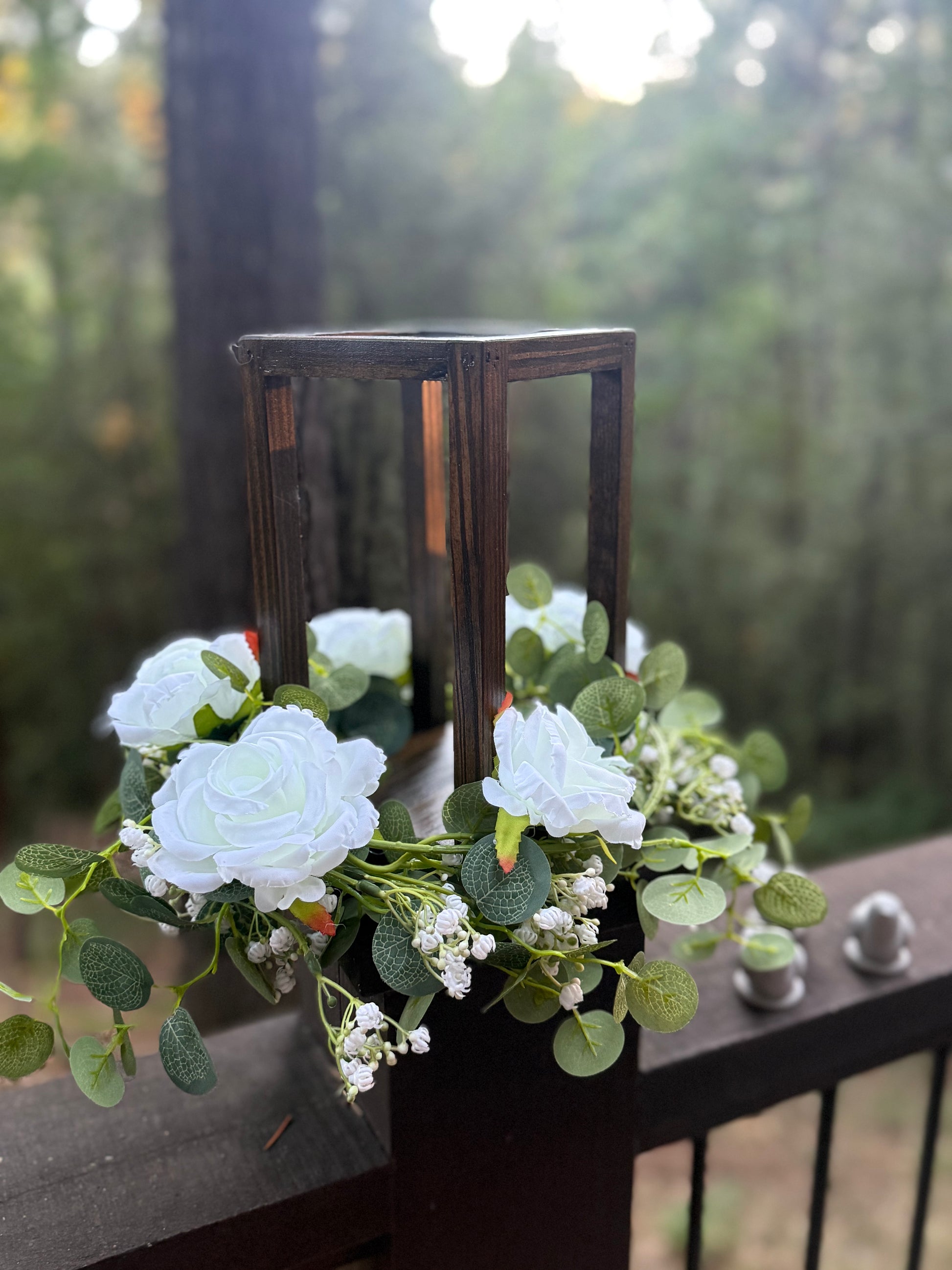 Close-up of wooden candle holder centerpiece with faux white florals and greenery | Reno, Lake Tahoe & Sacramento