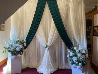 White chiffon drapery rental as full ceremony backdrop with white rose and greenery floral arrangement in natural outdoor light | Reno, Lake Tahoe & Sacramento