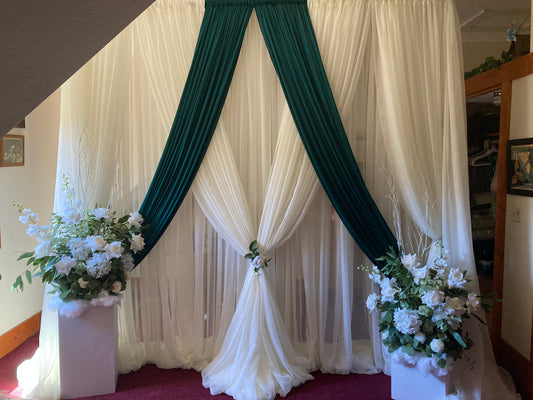 White chiffon drapery rental as full ceremony backdrop with white rose and greenery floral arrangement in natural outdoor light | Reno, Lake Tahoe & Sacramento