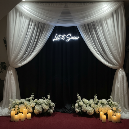 Light-Up LED "Let it Snow" Sign Rental mounted on flowing black spandex drapery backdrop with white florals and candles at base in cool white winter wedding lighting | Reno, Lake Tahoe & Sacramento