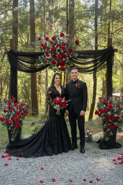Red rose arch adornment rental with black drapery styled with bride and groom in black wedding attire at outdoor forest ceremony | Reno, Lake Tahoe & Sacramento